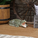 Outdoor polystone open-mouthed green crocodile statue on wood deck