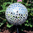 Mirrored diamond mosaic gazing ball globe shining in the backyard.