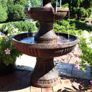 Base of fountain shown resting on patio pavers while water gathers in bottom tier