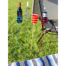 Outdoor drink holder stakes holding beverages in the backyard.
