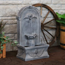 French-inspired outdoor wall-mounted fountain with running water displayed on the patio.
