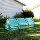 Mini cloche greenhouse with green polyethylene cover in shaded backyard with all three doors rolled down