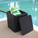 Black faux wood storage bin sitting pool side with a child life vest inside.