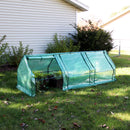 Mini cloche greenhouse with green polyethylene cover in shaded backyard with one of three doors rolled open to access the plants inside