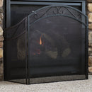 Decorative metal fireplace screen in front of an indoor fireplace to protect rogue sparks and ash.