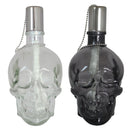 Front view of one white and one black clear skull torches with metal snuffer caps.