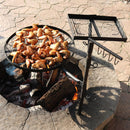 Dual swivel campfire cooking grate making chicken wings over a fire.