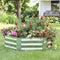 Hexagon, silver raised garden bed outside with plants growing inside