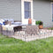 Bayonne-style 5-piece fence panels placed in grass connected to create a border around a backyard patio