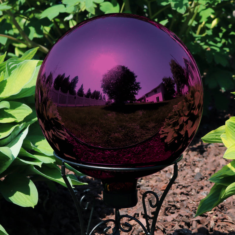 Mirrored surface gazing globe ball displayed in the garden.
