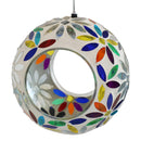 White and multi color round mosaic bird feeder hanging from a shepherd hook in the backyard.
