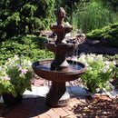 Base of fountain shown resting on patio pavers while water gathers in bottom tier
