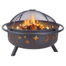 Front view of the black Cosmic Fire Pit with burning logs and flames beneath the domed mesh spark screen, highlighting the illuminated star and moon cutouts, circular fire bowl, side handles, and angled metal legs.