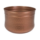 Rear view of the copper Hammered Iron Hose Pot, featuring a rounded metal design with a textured hammered finish and rolled upper rim.