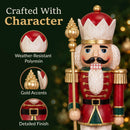 Close-up of a red and green Christmas nutcracker king holding a gold scepter, featuring callouts for weather-resistant polyresin, gold accents, and detailed finish.