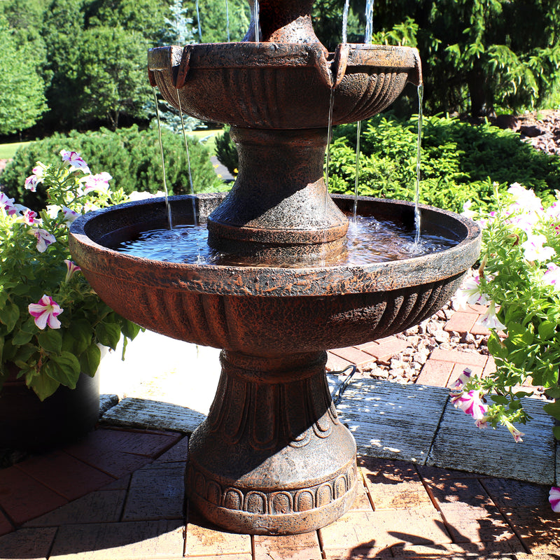 Base of fountain shown resting on patio pavers while water gathers in bottom tier
