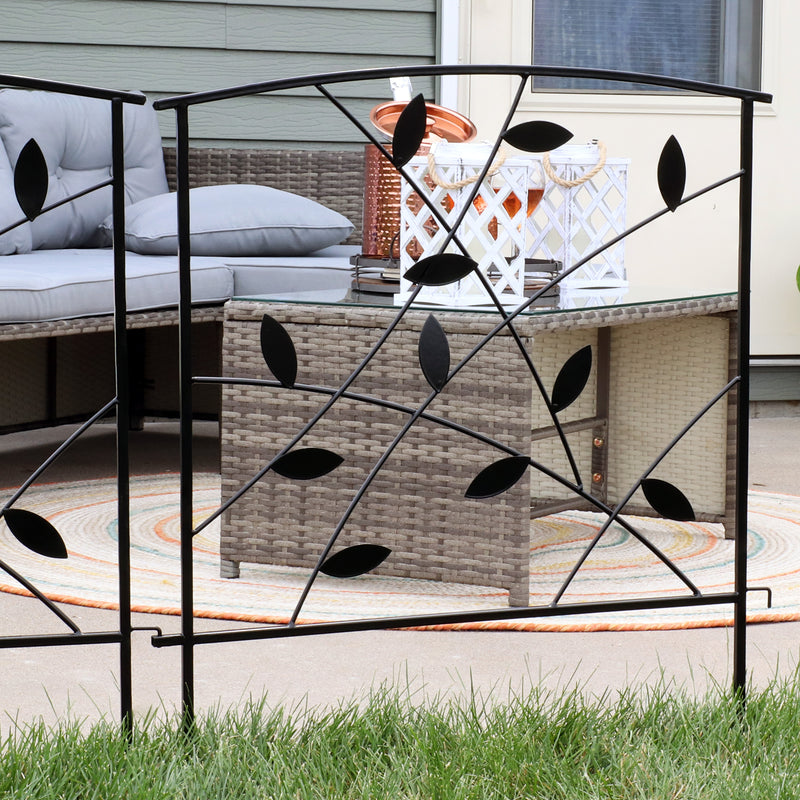 Single modern-style fence panel with decorative metal leaves placed in grass