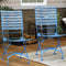Hand-painted blue folding, slatted chestnut bistro style dining side chairs on the patio.

