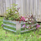 Square, silver raised garden bed outside with plants growing inside