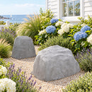 This coastal cottage scene shows both gray landscape rocks clearly, with the taller, narrower rock in the background and the shorter, wider rock in the foreground. The hydrangeas, lavender, ornamental grasses, and light gravel closely match the intended setting.