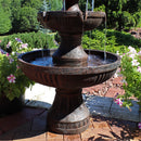 Base of fountain shown resting on patio pavers while water gathers in bottom tier
