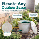 Ivory Glaze Decorative Metal Garden Hose Holder shown storing a coiled garden hose, featuring an open-top design for easy access, a removable lid for a clean concealed look, and a decorative glaze finish for a refined outdoor appearance.