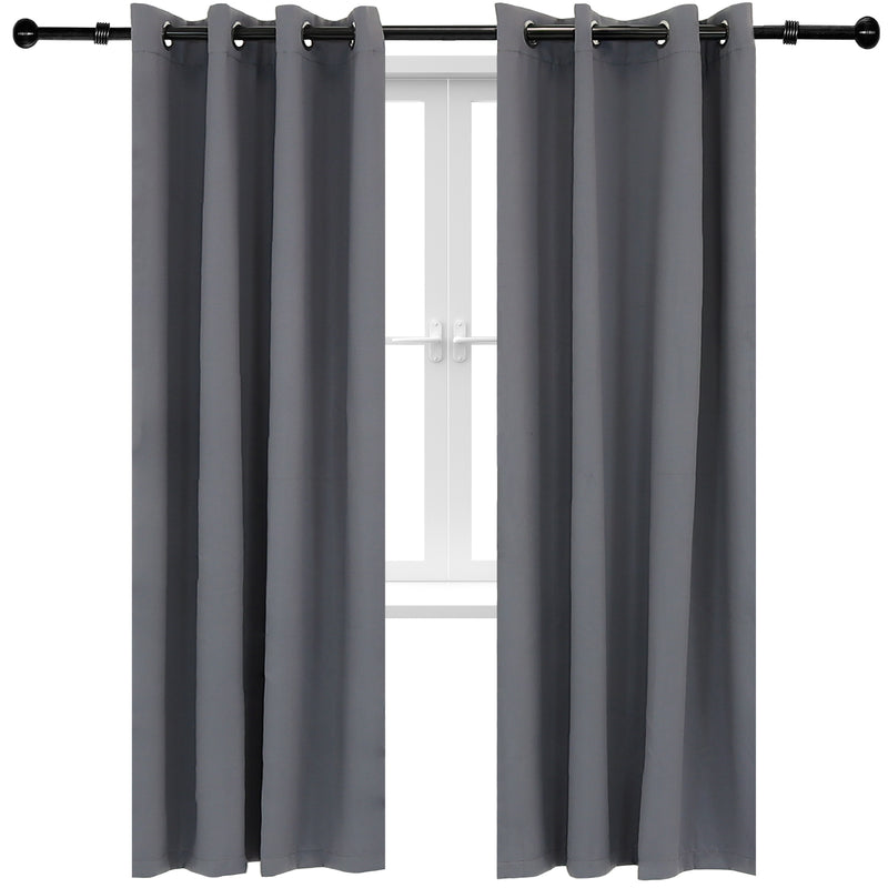 Two gray curtains hug from a black curtain rod in front of a white trimmed window.
