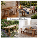 Sunnydaze Teak Trestle Bench in four different situations, the top left is in a dining room farm house interior aesthetic, the top right is by a campfire in a backyard, the bottom left is in a garden with dappled lighting, and the final image is at the foot of the bed in a clean minimalistic scene.