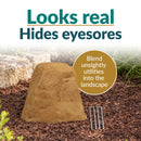 Infographic featuring a tall, tapered tan faux rock cover with a realistic stone texture in a mulched garden bed. Text reads “Looks real, Hides eyesores” with a callout explaining how it blends unsightly utilities into the landscape. Two metal ground stakes are displayed beside the rock.