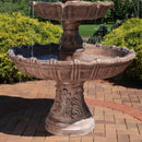 Bottom tier and pedestal of a large tiered fountain on a brick stone patio.