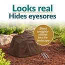 Infographic featuring a dark brown faux rock cover with a realistic stone texture in a mulched garden bed. Text reads “Looks real, Hides eyesores” with a callout explaining how it blends unsightly utilities into the landscape. Three metal ground stakes are displayed beside the rock.