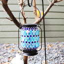 Blue mosaic lantern hanging from a shepherds hook.