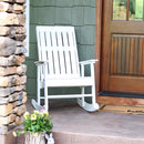 White rocking chair with wide armrests sitting on a front porch.