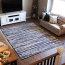 7 x 10 blue and white striped rug laid out in the center a living room