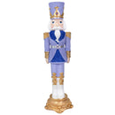 Purple, blue, white, and gold decorative Christmas nutcracker statue with a tall hat, ornate details, and a gold decorative base, shown on a white background.