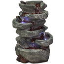 Six-Tier Stone Falls Tabletop Fountain DW-34107 displayed on a white background. The image features a decorative tabletop fountain with a stacked six-tier stone waterfall design. The fountain has a natural stone-like appearance with multiple cascading levels, creating a soothing water feature suitable for indoor or outdoor décor, offices, patios, gardens, and living spaces.