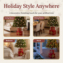 Present Pile Decorative Christmas Tree Base shown with artificial Christmas trees in a living room, dining room, bedroom, and covered porch, highlighting its decorative stacked gift box design for a variety of seasonal spaces.