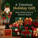 Traditional Christmas nutcracker decoration dressed in a festive red, green, black, and gold uniform, holding a holiday wreath and candy cane while standing on a Merry Christmas base. Displayed beside beautifully wrapped red and green Christmas presents with decorative ribbons, highlighting its charm as a timeless holiday gift.