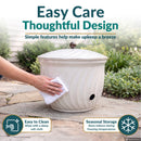 Ivory Glaze Decorative Metal Garden Hose Holder shown being wiped clean with a soft cloth, highlighting simple maintenance and recommended indoor storage during freezing temperatures.