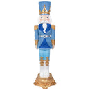 Front view of a tall blue, white, and gold Christmas nutcracker statue with a textured blue hat and uniform, gold accents, white boots, and an ornate gold base.