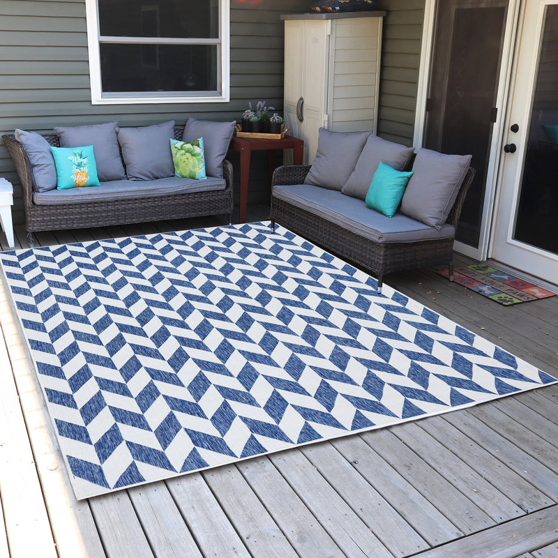 Geometric patterned rug on an outdoor deck between two couches