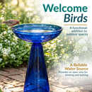Blue glass birdbath filled with water, with a small bird perched on the edge. Text highlights welcoming birds, outdoor use, and providing a reliable water source for drinking and bathing.
