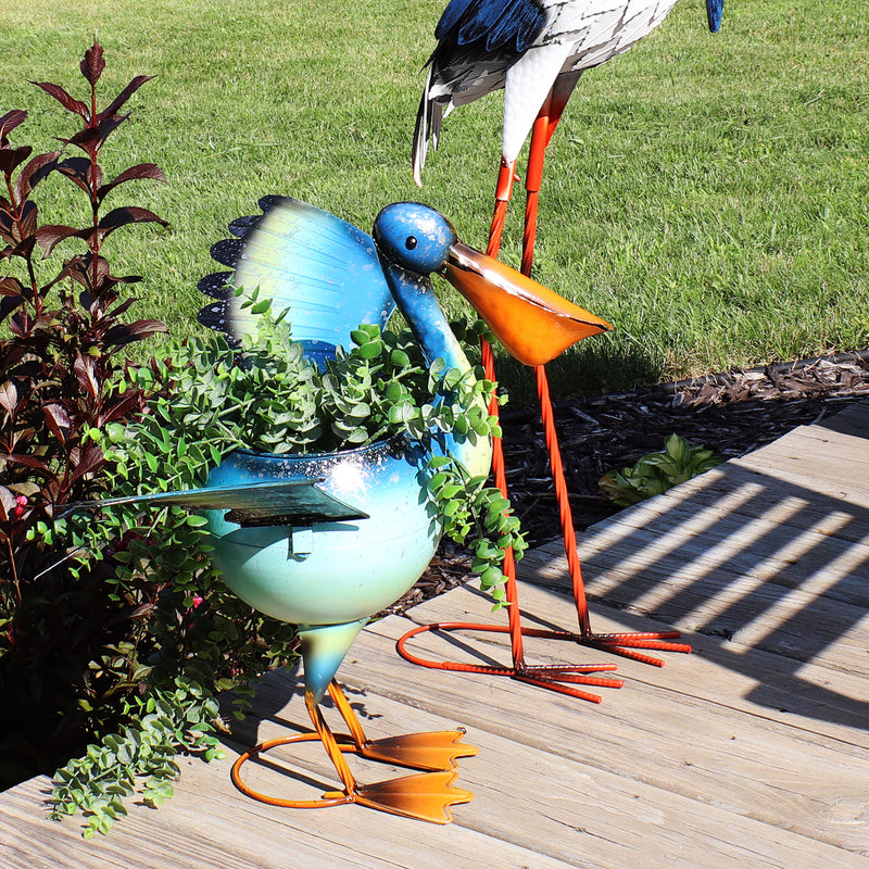 Back view showing the tail of the blue, metal pelican planter statue.