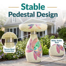 Mosaic Bloom Glass Bird Bath in rainbow shown outdoors in a garden, featuring a secure bowl connection and a wide, stable pedestal base with colorful floral mosaic accents.