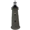 Weathered brown and green lighthouse statue with a black lantern, metal railing, and two cutout windows displayed against a white background.
