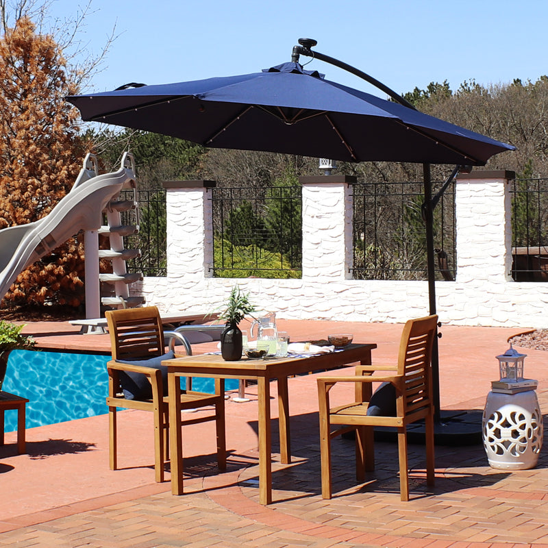Sunnydaze 10-Foot Offset Cantilever Solar Patio Umbrella with Outdoor LED Lights, Crank, and Cross Base, Navy Blue Sunnydaze 10-Foot Offset Cantilever Solar Patio Umbrella with Outdoor LED Lights, Crank, and Cross Base, Navy Blue