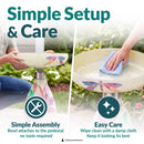 Mosaic Bloom Glass Bird Bath in rainbow shown being assembled and cleaned outdoors. The bowl attaches to the pedestal without tools, and the glass surface can be wiped clean with a damp cloth.