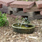 Green ceramic frog spitting water out it's mouth into the ceramic basin.