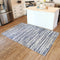 5 x 7 blue striped indoor rug laid out on a hardwood floor in front of kitchen island
