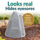 Light gray faux rock utility cover with a realistic stone texture displayed in a landscaped garden. Text highlights its natural appearance and ability to conceal unsightly utilities. Four metal ground stakes are shown beside the rock.